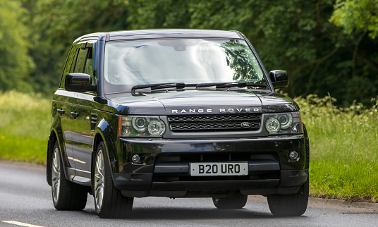Stony Stratford,UK - June 2nd 2023: 2009 black RANGE ROVER SPORT travelling on an English country road