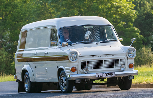 Stony Stratford,UK - June 4th 2023: 1974 white FORD TRANSIT van  classic car travelling on an English country road.