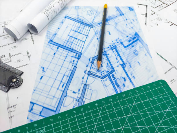 istock Pencils, ruler, green matte and paper engineering house drawings and blueprints. 1495851527