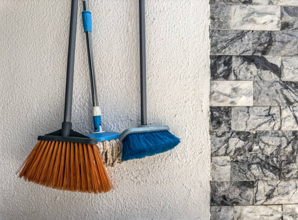 broom standing in front of wall