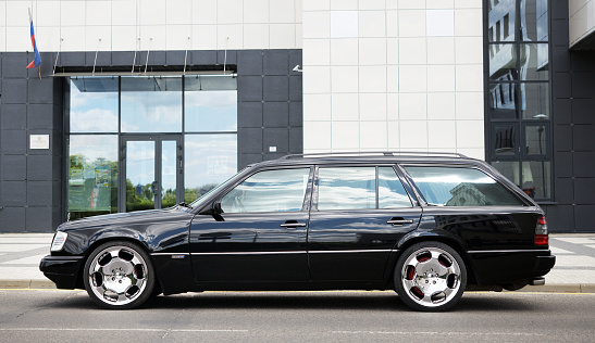 Belarus, Minsk -04.16.2023:Black Mercedes Benz w124 station wagon parked on the street.Mercedes Benz Classic W124-1990 series.