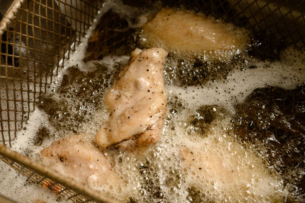 istock Cooking chicken wings in a deep fryer 1495854683