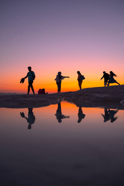 istock People walking by the lake at sunset 1495863197