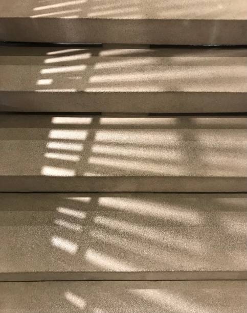 istock Shadow of fence on concrete step stairs 1495864285