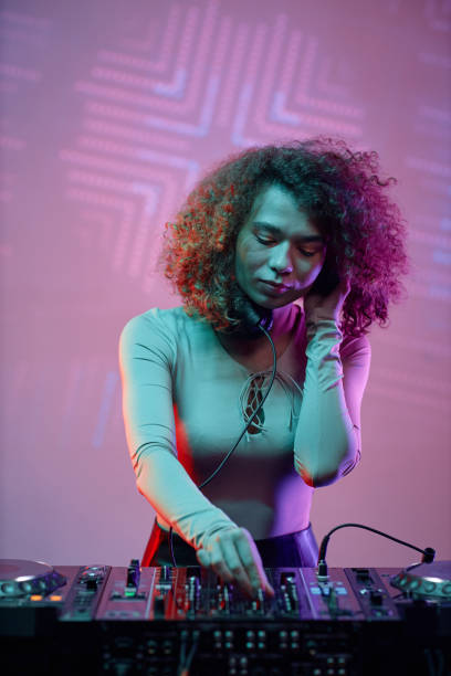 istock Young woman DJ making music 1495866444