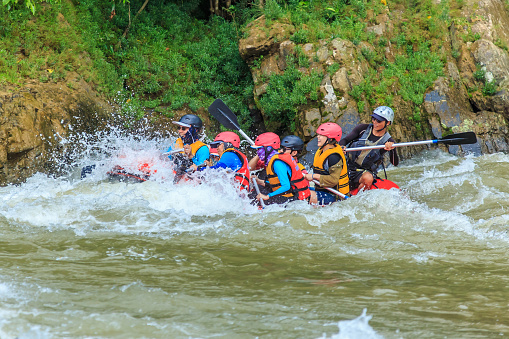Kiulu Sabah, Malaysia - May 29, 2018: Group of people doing white water rafting activity at Kiulu river Sabah Malaysian Borneo.