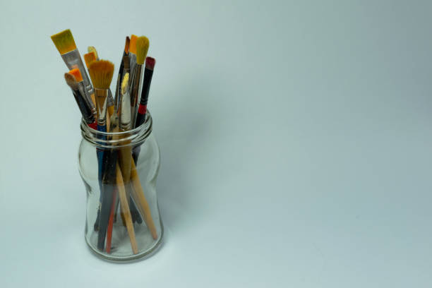 istock Art brushes in a glass jar 1495872797