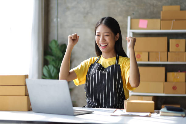 istock Young small business entrepreneur working with laptop and parcel boxes preparing for delivery. 1495874952