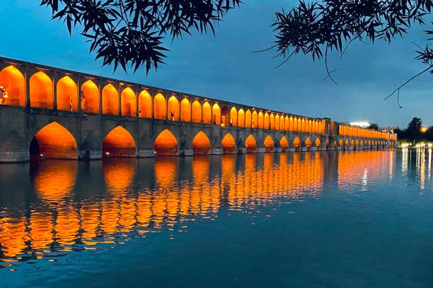 The famous Khaju Bridge stands above the dry riverbed of Zayandeh Rud during a severe drought in Isfahan, Iran, symbolizing the environmental impacts of water shortage in the region.