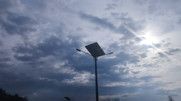 istock Street lights using solar panels with clouds in the background 1495880558