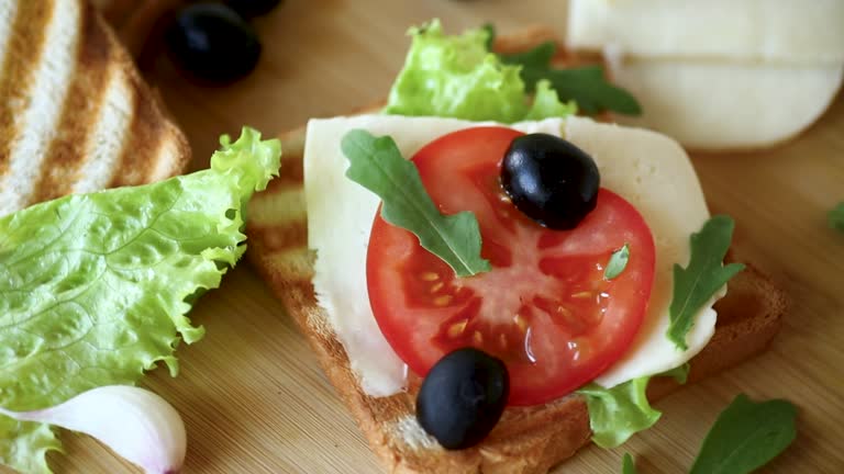 fried toasts with mozzarella, lettuce and tomatoes with herbs