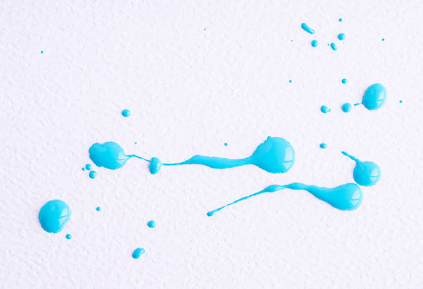 Watercolor light blue drop splash. Splattered of bright blue ink drops on white paper background. Sample of cosmetics on a white background. The puddle of an oil paint spill.