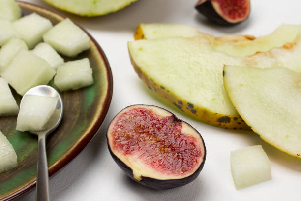 istock Figs and melon slices on a plate. Melon wedges. Close up. 1495888683
