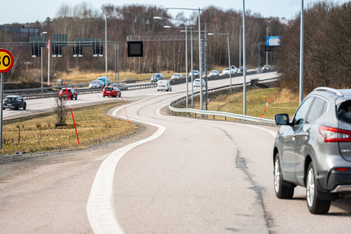 Gothenburg, Sweden - March 14 2023: Curvy highway onramp with snow sticks.