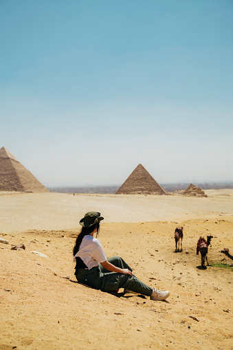 Pyramids of Giza, Giza Necropolis, Egypt - July 26, 2022: The Giza Necropolis is a large area near Giza, a suburb of Cairo that has many tombs and burial sites. It is also where you can find the famous Pyramids of Giza, the Great Sphinx, and more. The name comes from the ancient Greek word nekropolis, which literally means “city of the dead”.\n\nThe Giza Complex was once near the ancient Egyptian capital of Memphis, and the Giza plateau is where a number of pharaohs, queens, and nobles of the Fourth Dynasty of ancient Egypt were buried. \n\nAll three of Giza's pyramids and their elaborate burial complexes were built  from roughly 2550 to 2490 B.C. The pyramids were built by Pharaohs Khufu, Khafre, and Menkaure.