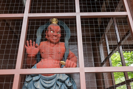 Japanese red demon statue at entrance of Daibutsu temple in Kamakura City, Kanagawa, Japan. Famous travel destination.