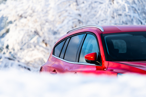 Stenungsund, Sweden - January 03 2023: Red estate car on a parking lot in winter.