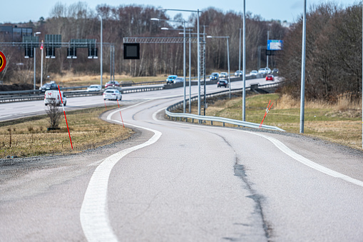 Gothenburg, Sweden - March 14 2023: Curvy highway onramp with snow sticks.