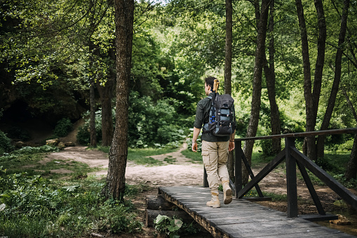 Young male hiker on a  bridge