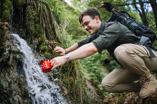 istock Hand pouring water in cup outdoor 1495894910