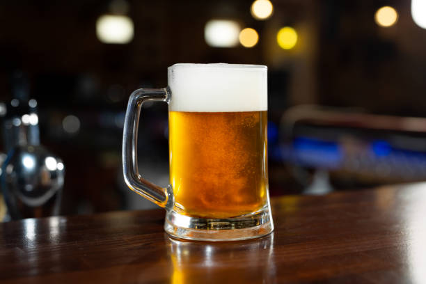 istock Glass of light beer on a dark pub. 1495895117