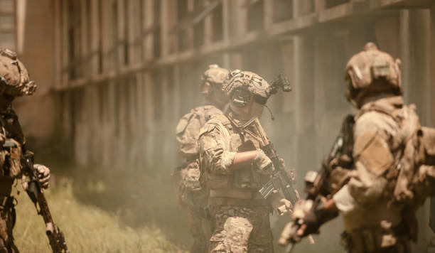 istock Professional marine soldiers training with weapon on a military range. 1495895181