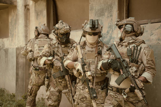 istock Professional marine soldiers training with weapon on a military range. 1495895263