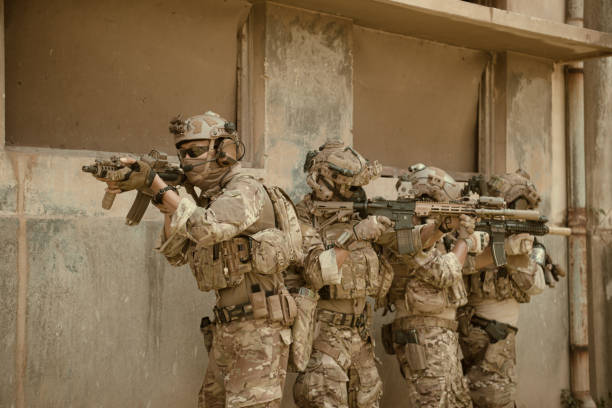 istock Professional marine soldiers training with weapon on a military range. 1495895276