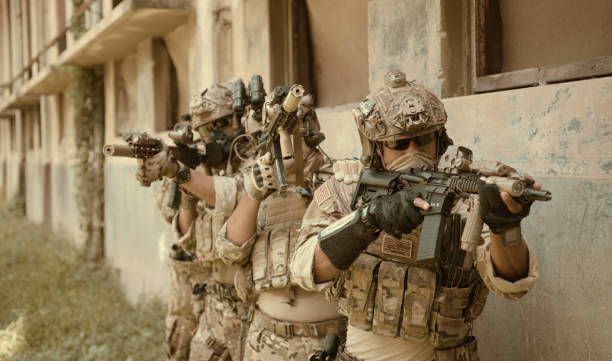 istock Professional marine soldiers training with weapon on a military range. 1495895278