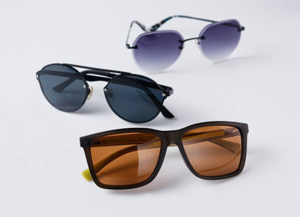 istock sunglasses with brown, blue, purple lenses on a white background, copy space 1495897261