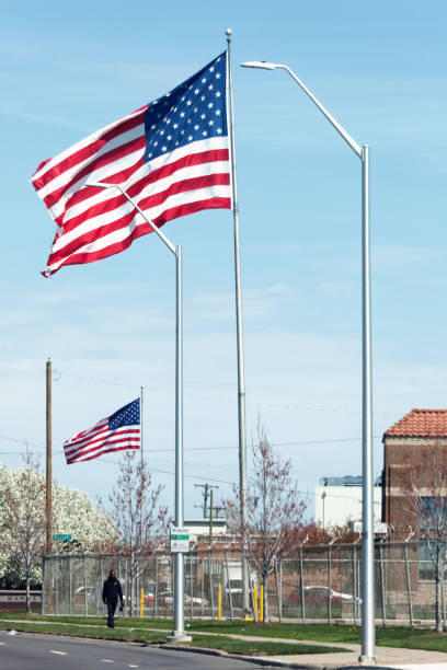 Detroit, Michigan, USA - A person walks under huge American flags somewhere in inner city