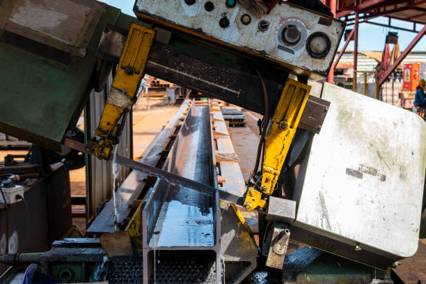 Cutting steel H-Beam with a band saw machine.