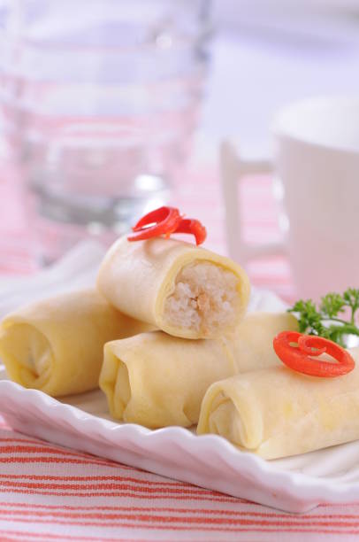 istock Serving a snack from Indonesia named Semar Mendem. Made from glutinous rice, coconut milk, filled with chicken and wrapped in omelette dough 1495901390