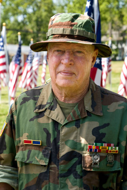 istock Vietnam War Combat Veteran standing among American Flags 1495901694