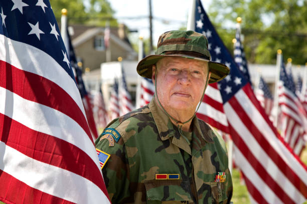 istock Vietnam War Combat Veteran amongst American Flags 1495901737
