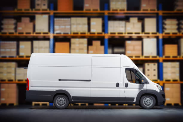 istock Commercial delivery van in warehouse with cardboard boxes.  Delivery, logistic  and shipment concept. Space for text. 1495901970