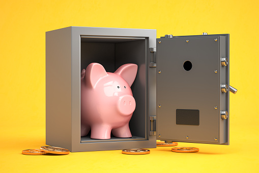 Piggy bank in vault safe.  Bank savings,  financials investments, saving  for retirement money secure concept. 3d illustration