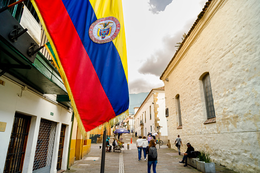 Close-up of a Colombian flag hanging from a balcony in a street in La Candelaria