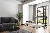 Living Room Interior With Sofa, Coffee Table, Barbell And Dumbbells. Training At Home With Sports Equipment