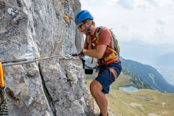istock Man on Via Ferrata climbing up, summer activities concept 1495904834