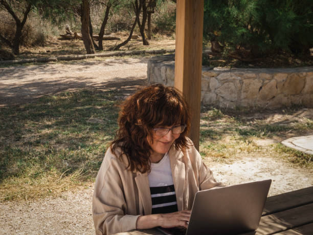 istock smiling woman in front of computer 1495908123