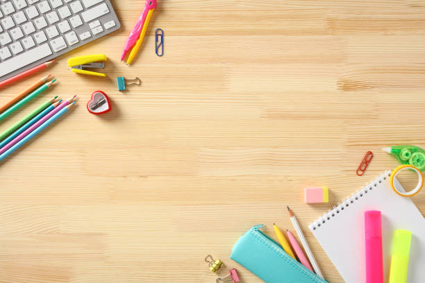 istock School supplies frame on wooden desk. Top view. Flat lay. 1495913931