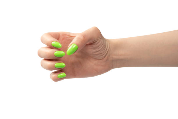 istock Hand of a woman with green naols hold some tiny or thin object. 1495916503