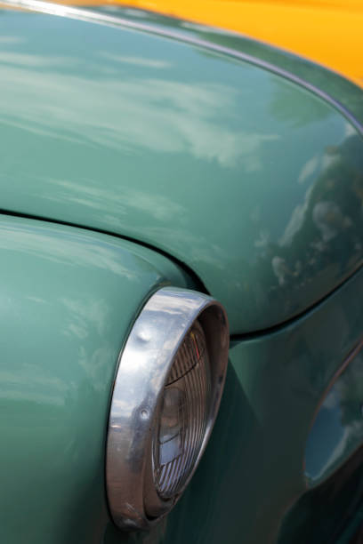 istock Headlight on pastel green retro car. 1495916737