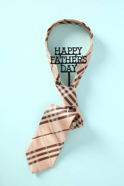 istock Happy Father's Day concept. Tie with message Happy Fathers Day on blue table. 1495919028
