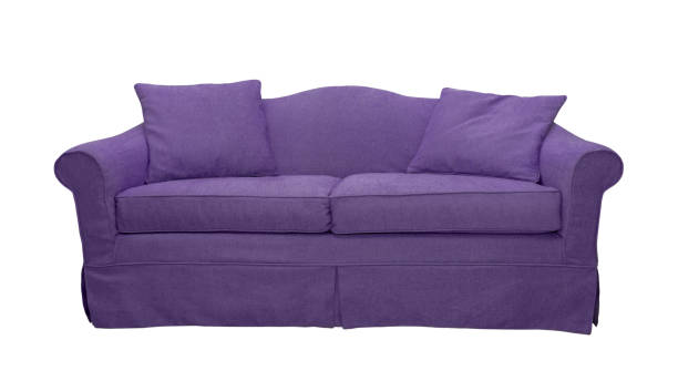 istock Purple sofa with pillows isolated on white background 1495920511