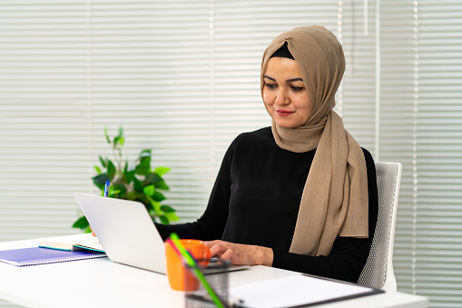 Portrait of a muslim woman working in a office