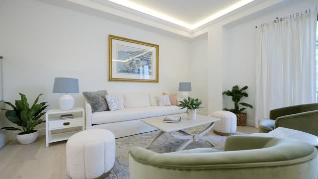 Cozy living room at modern house with seating set around made in white, blue and green colors. Stylish design creating exquisite atmosphere for family relaxation