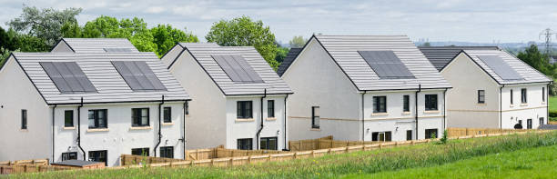 istock Solar panels installed on home roofs at new housing development 1495924934