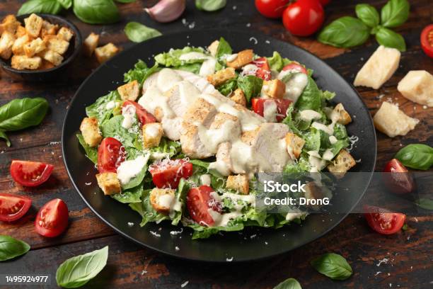 A Delicious Chicken Caesar Salad With Parmesan Cheese Tomatoes Croutons And Dressing Stock Photo - Download Image Now